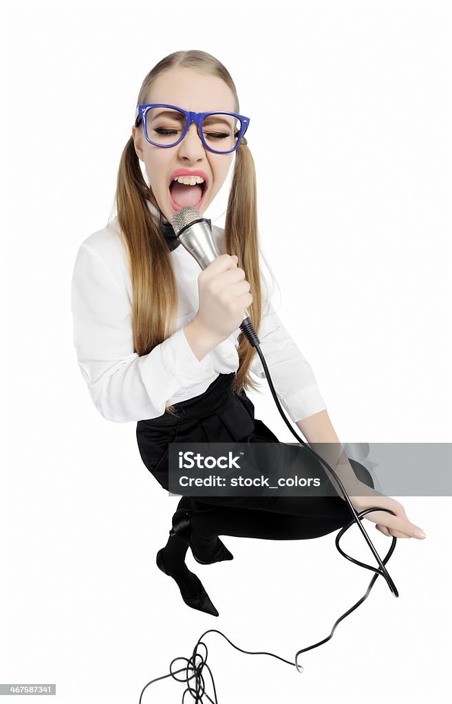 singing and having fun funny nerd with horn rimmed eyeglasses singing at microphone. 20-29 Years Stock Photo