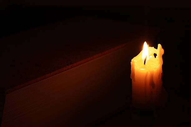 istock Burning candle near the book 467587392