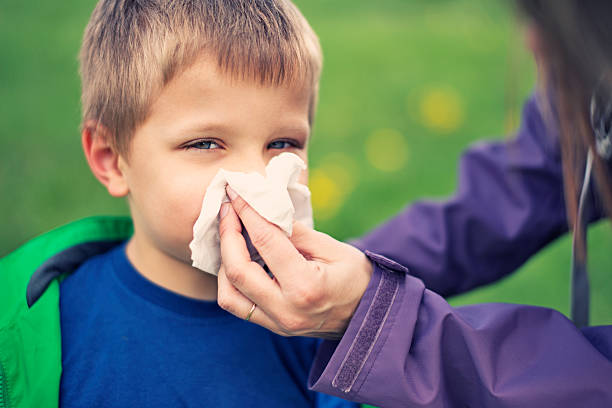 istock Mother cleaning nose of sick son 467587804
