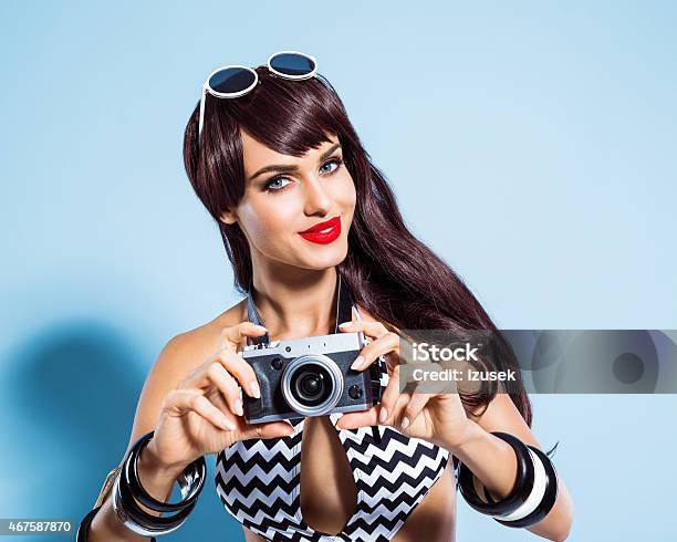 Smiling Young Woman Wearing Swimsuit Taking Picture Using Camera Stock Photo - Download Image Now