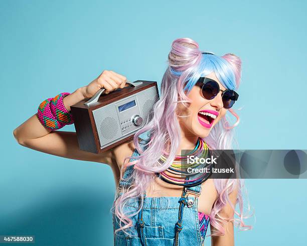 Pink Hair Girl In Funky Manga Outfit Holding Small Radio Stock Photo - Download Image Now