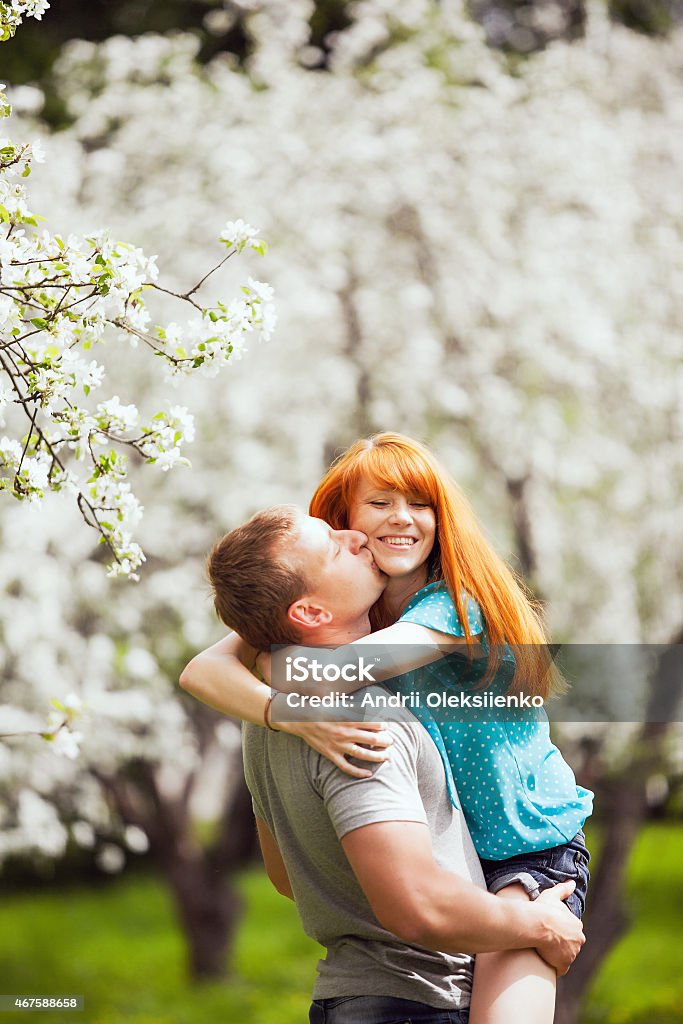 beautiful couple in love beautiful couple in love having fun outdoors in spring garden full of blooming apple-trees 2015 Stock Photo