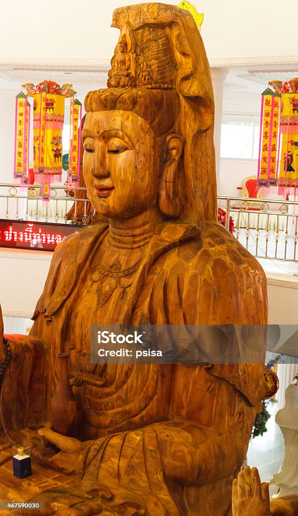 wooden goddess of mercy (Guan Yin) statue wooden goddess of mercy (Guan Yin) statue in asian temple 2015 Stock Photo