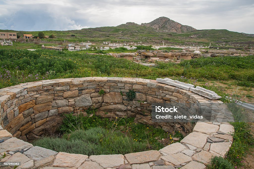 Ancient Greek ruins at the archaeological island of Delos Ancient Greek ruins at the archaeological island of Delos, Cyclades, Greece 2015 Stock Photo