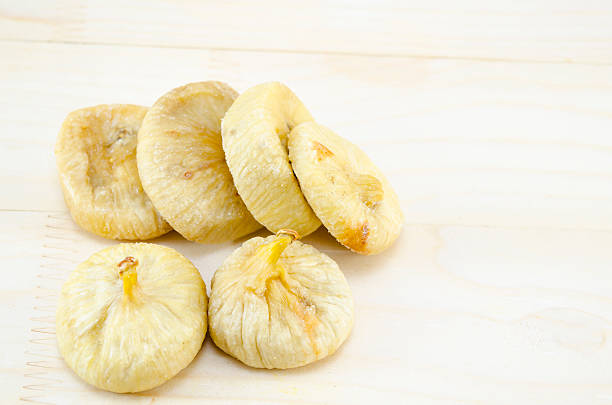 istock Dried figs on a wooden table 467590874