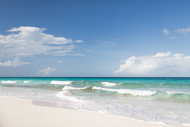 istock blue sea or ocean, white sand and sky with clouds 467594214