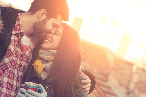 Attractive couple outdoors on a coffee break.