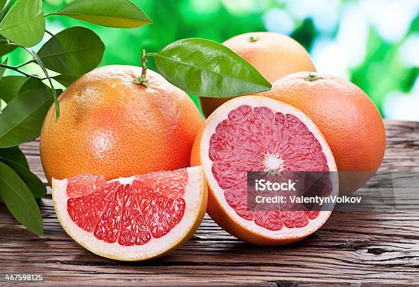 Grapefruits On A Wooden Table Stock Photo - Download Image Now - Grapefruit, Bush, Citrus Fruit