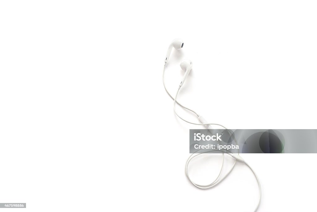 white earphones on white background, blank text In-ear Headphones Stock Photo