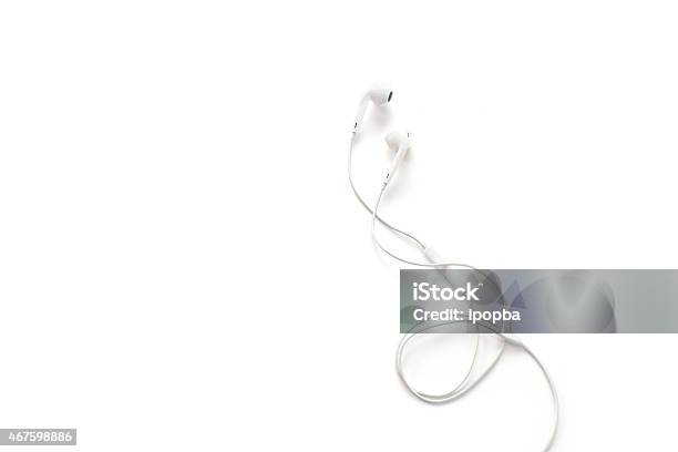 White Earphones On White Background Blank Text Stock Photo - Download Image Now - In-ear Headphones, White Color, Headphones