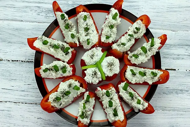 red pepper stuffed with white cheese on a plate 