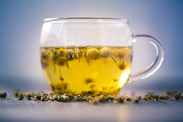 Camomile tea on white background. Directly above.