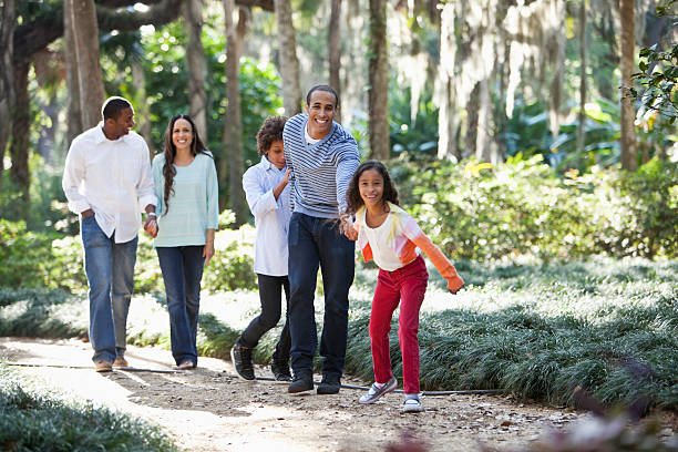 istock Interracial family walking in park 467604893