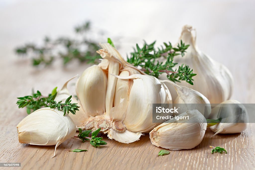 garlic on wooden table garlic and  thyme on old wooden tablegarlic on a old wooden table 2015 Stock Photo