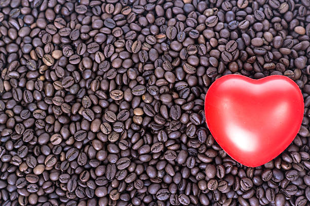 istock red heart on the coffee beans background. View from above. 467609832