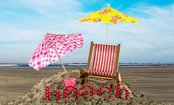 istock umbrellas and beach text in the sand 467611010