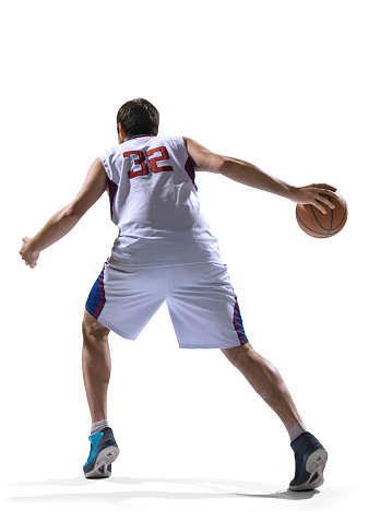 Isolated on white professional basketball player standing holding basketball