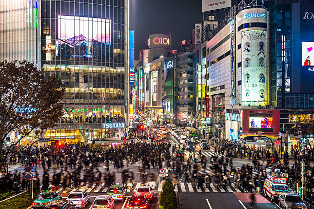 Tokyo Japan Tokyo, Japan - December 15, 2012: Pedestrians cross at Shibuya Crossing. The intersection is known as the busiest in the world. shibuya district stock pictures, royalty-free photos & images