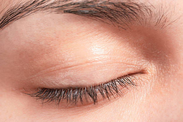 istock Close-up of woman's eyelid including eyelashes and eyebrow 467617237