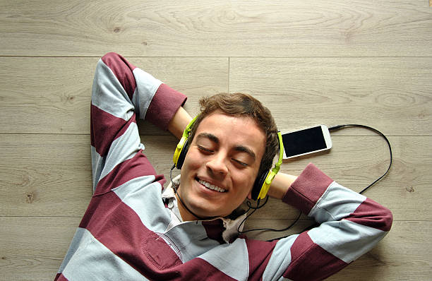 istock Young man listening to music 467618210