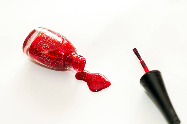 istock Red nail polish bottle dripping on isolated on white. 467618696