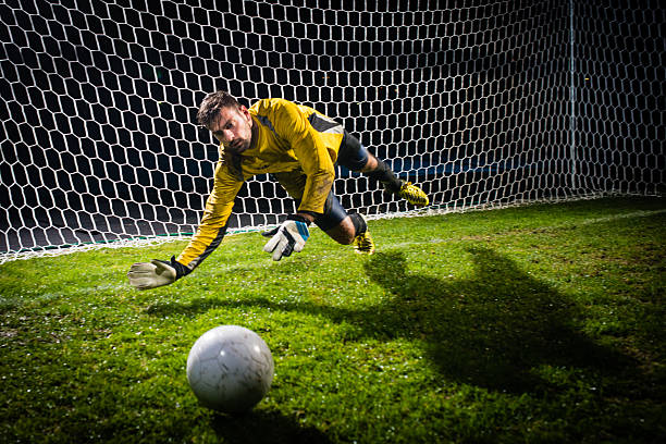 istock Soccer Goalie Jumping For Ball 467618892