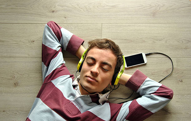 istock Young man listening to music 467621196