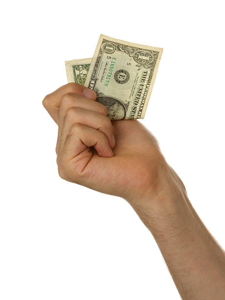istock Man holding a one dollar bill in his hand 467621915
