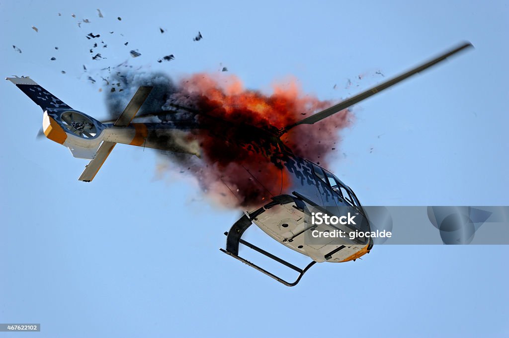 Ground view looking up at a helicopter exploding mid air helicopter exploding in flight Helicopter Crash Stock Photo