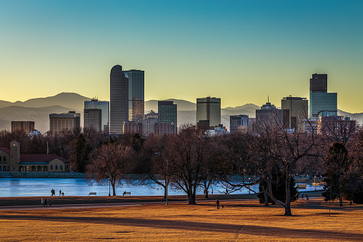 Denver City skyline and City Park at sunset in warm orange glow 