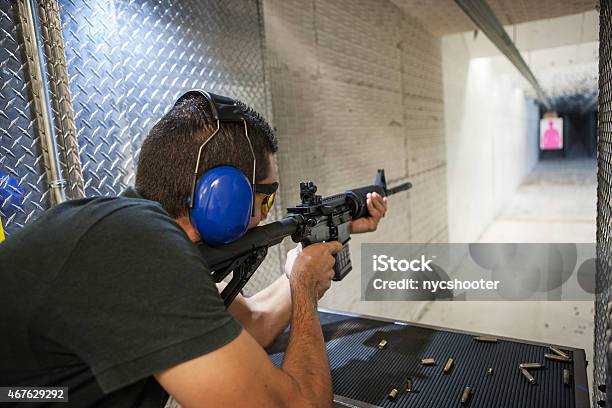 Closeup Of Man Firing An Assault Rifle Stock Photo - Download Image Now - Gun, Safety, Target Shooting