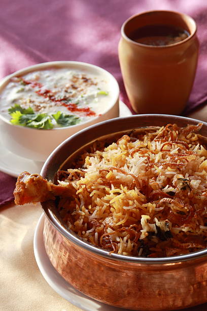 Hyderabadi Biryani - A  Popular Chicken or Mutton based dish Hyderabadi Biryani - is perhaps the most well-known Non-Vegetarian culinary delights from the famous Hyderabad Cuisine. It is a traditional dish made using Basmati rice, goat meat and various other exotic spices. jammu and kashmir photos stock pictures, royalty-free photos & images