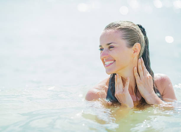 istock happy young woman standing in sea looking on copy space 467633003