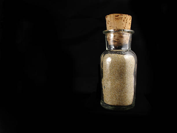 istock transparent glass bottle with sand 467633719