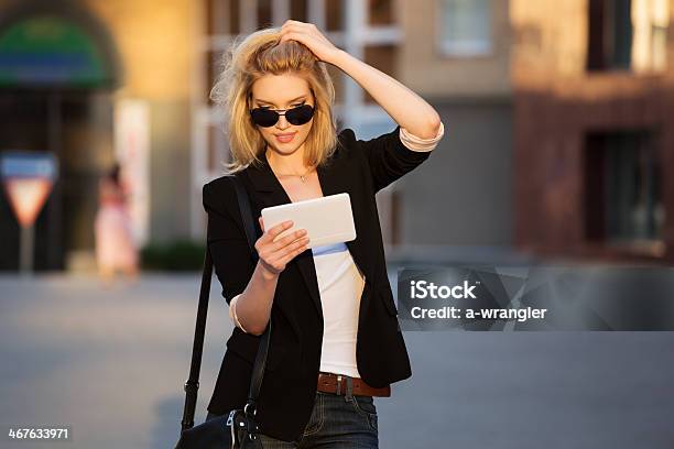 Joven Mujer De Negocios Usando Una Tableta Digital Foto de stock y más banco de imágenes de Andar - Andar, Negocio, Tableta digital