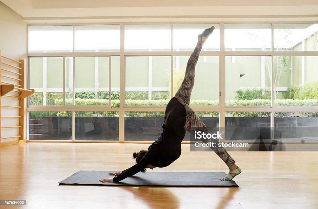 Woman at Pilates Excercise A 29 year old woman doing Pilates exercises. 2015 Stock Photo