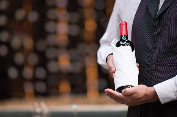 istock Sommelier holding a bottle of wine 467634838