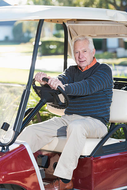istock Senior man driving a golf cart 467634982