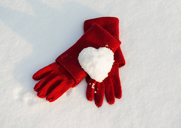 istock Red gloves and snow heart 467637227