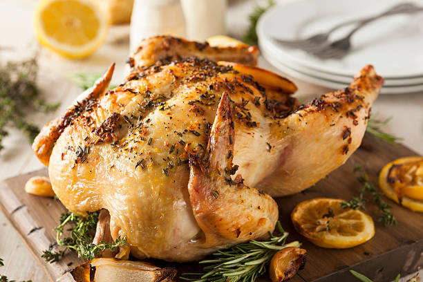 Homemade Lemon and Herb Whole Chicken Homemade Lemon and Herb Whole Chicken on a Cutting Board vitamin rich stock pictures, royalty-free photos & images