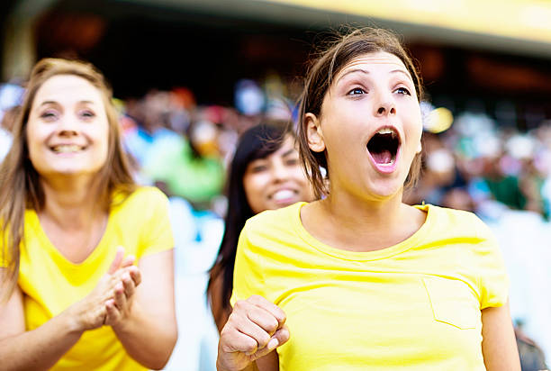 istock Three ecstatic female soccer fans support thier team 467640073