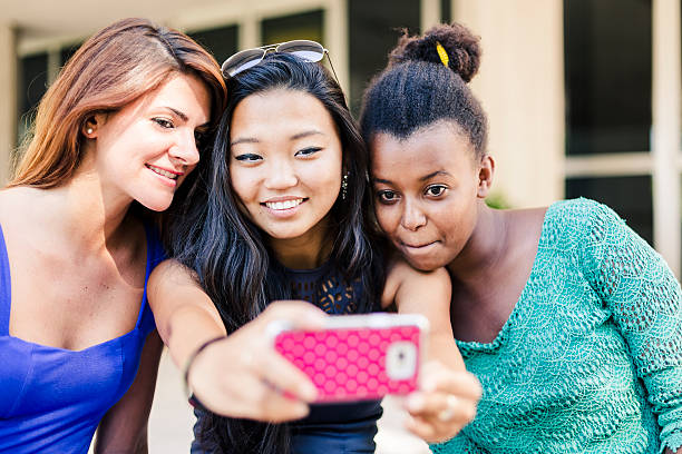 istock Three young women taking self portrait 467640179
