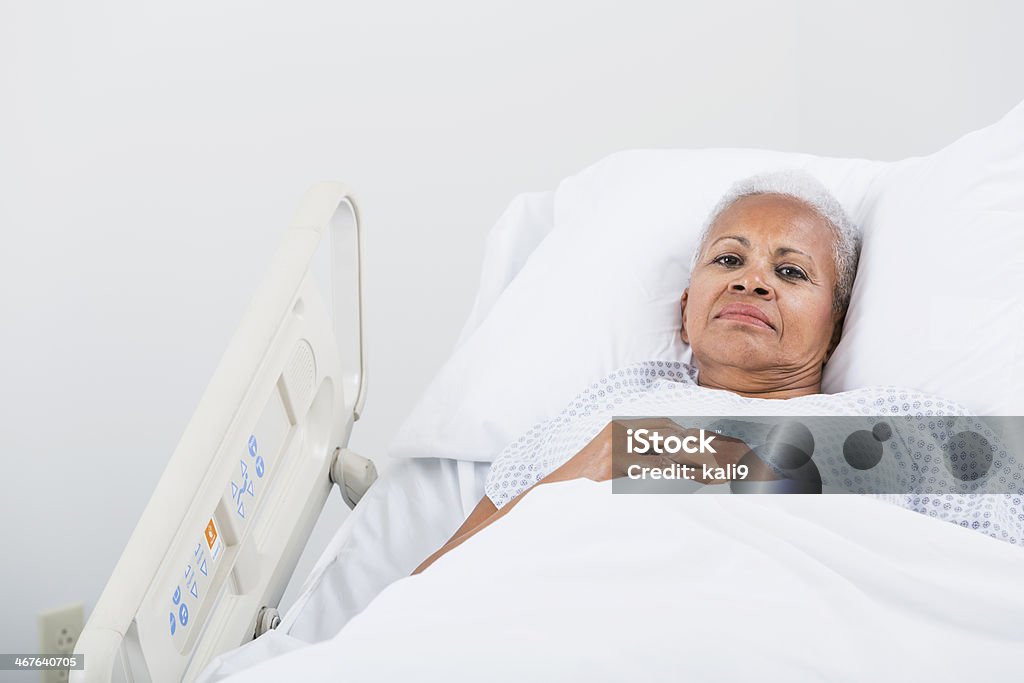 Hospital patient Senior African American woman (60s) lying on hospital bed. Hospital Stock Photo