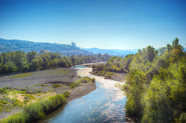 French summer landscape with medieval tower French summer landscape with medieval tower. The village of Cres with its medieval donjon/tower and the Vercors mountains in the background, taken from a bridge over the Drome River in the south of France drome stock pictures, royalty-free photos & images