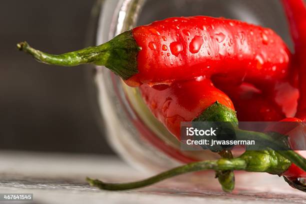 Macro Organic Jalapeno Peppers Spilling Out Of Mason Jar Stock Photo - Download Image Now