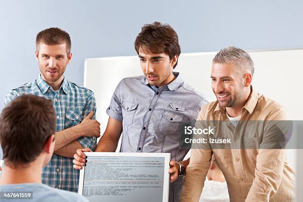 Men Discussing Project Stock Photo - Download Image Now - 30-39 Years, Adult, Adult Student