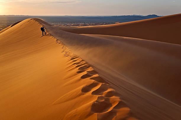 istock Man on Erg Chebbi Sand Dune at Sunrise, Morocco, Africa 467641985