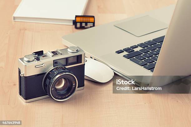 Vintage 35 Millimeter Camera Next To Open Laptop And Mouse Stock Photo - Download Image Now