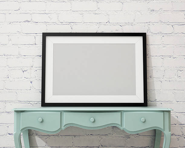 istock blank picture frame on the white desk and wall 467644426