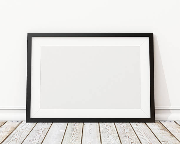istock An empty black picture frame leaning against a wall 467644460